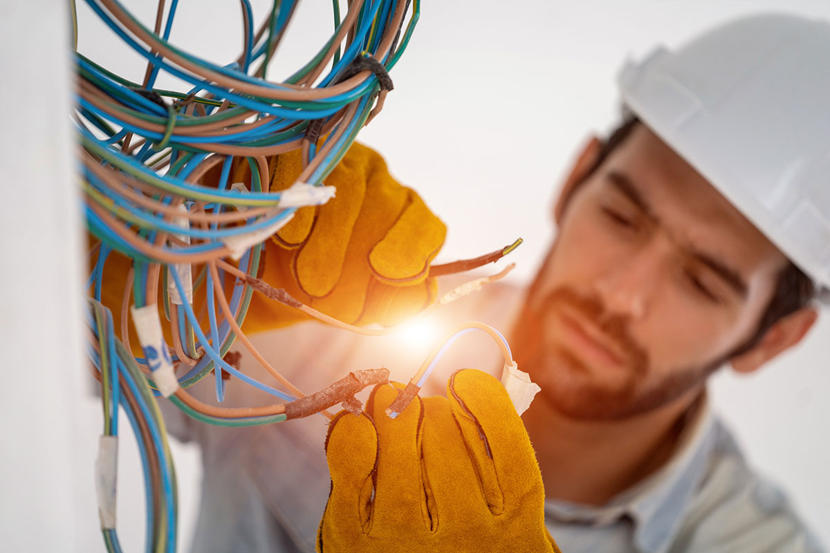 MG Electric licensed electrician installing wiring at a worksite in Sac City, Iowa